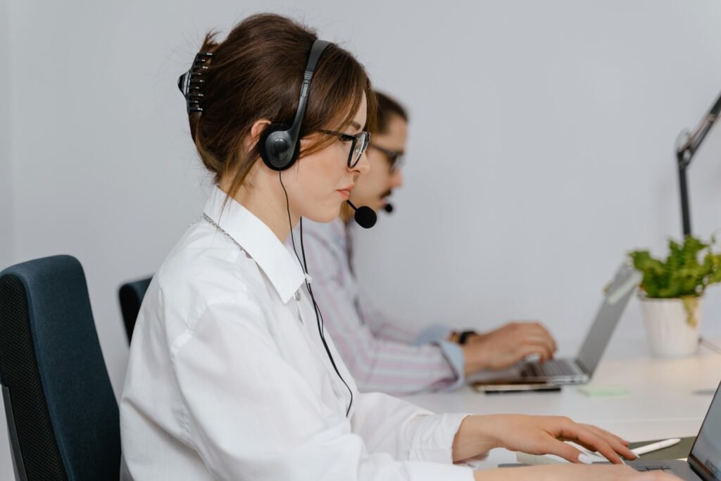 pexels-photo-7709278-7709278 Customer service agents working at call center with headsets, focused on providing support.